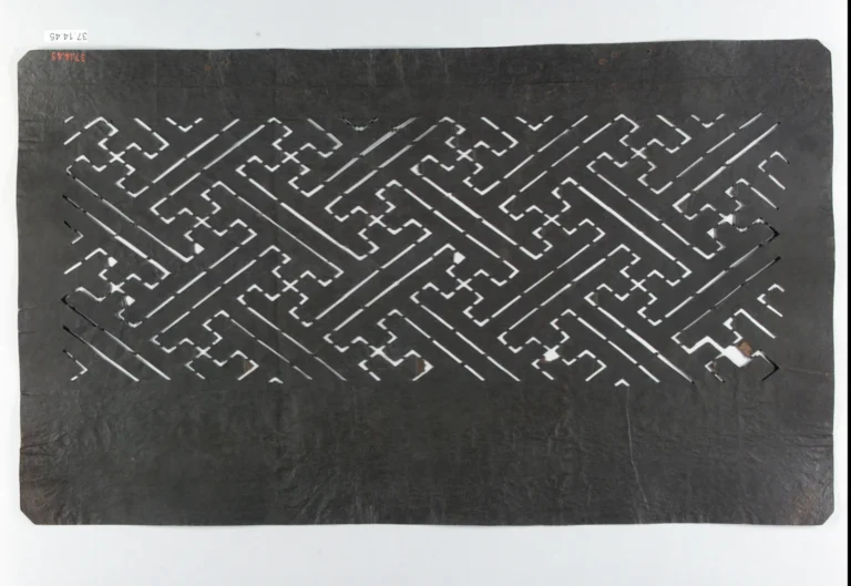A carved paper dye stencil with a continuous sayagata fret pattern