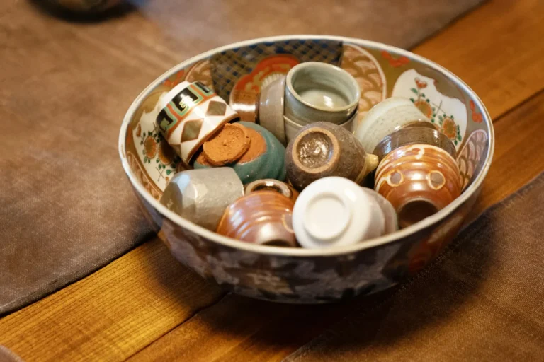 Decorative bowl filled with various small ceramic cups