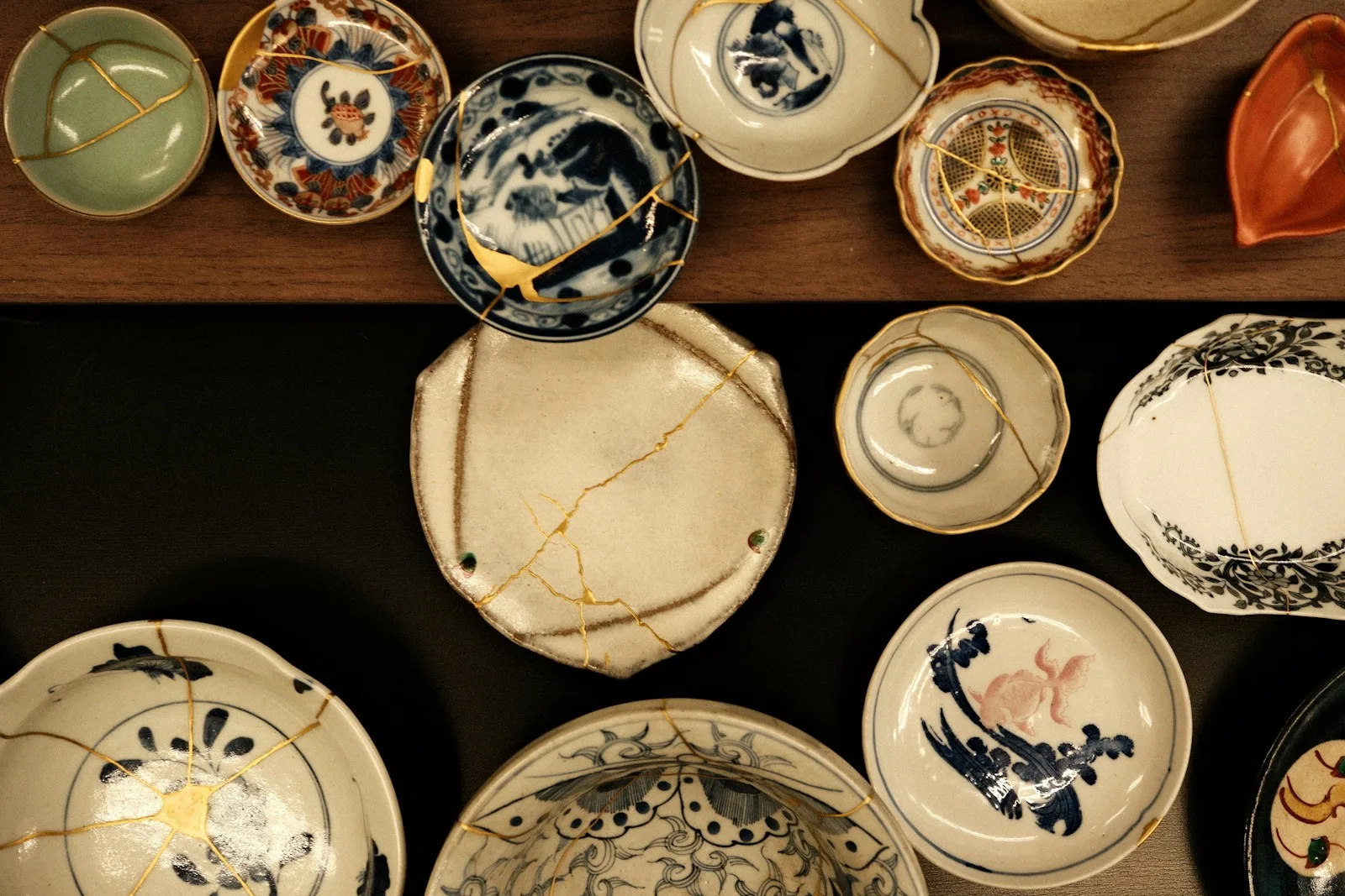 Collection of ceramic dishes, many repaired with gold kintsugi