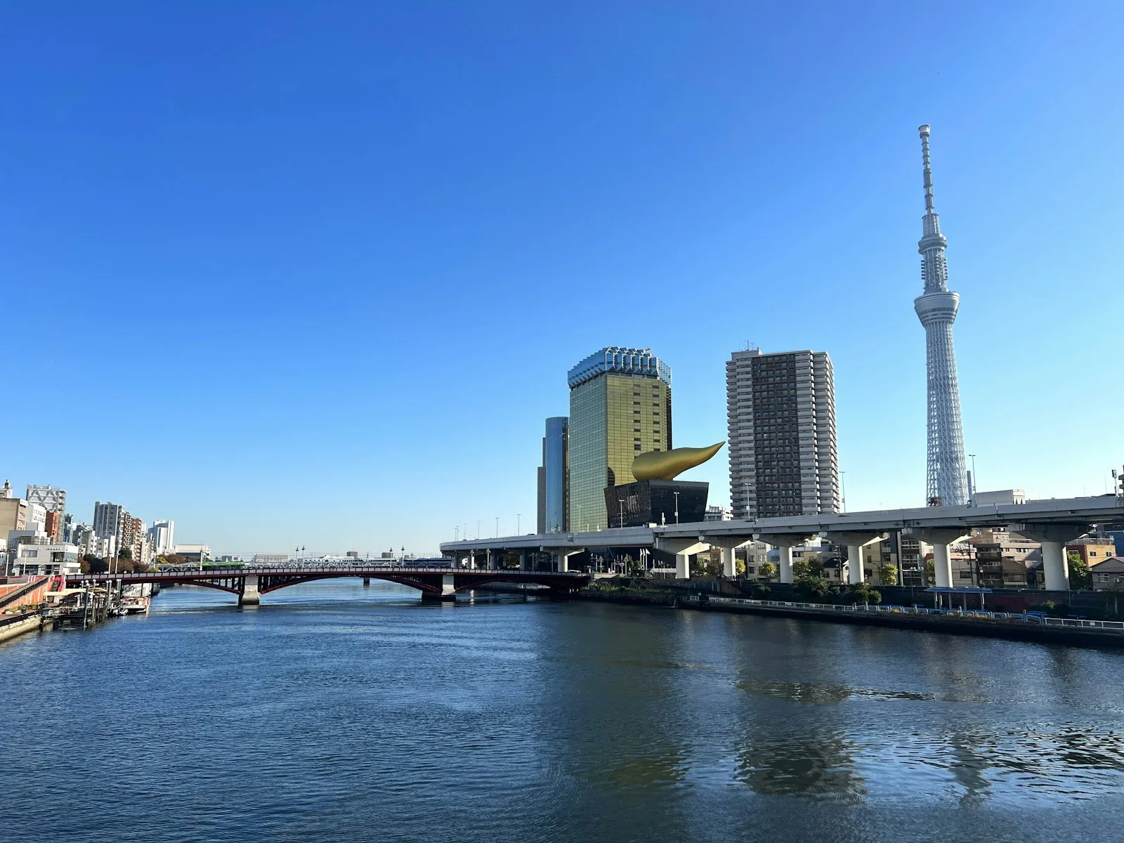 A river running through a city next to tall buildings