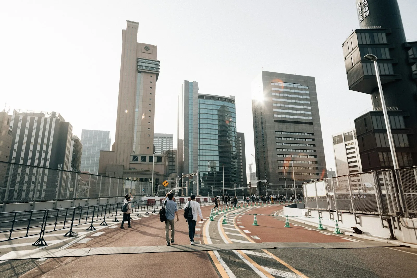 People walking on a path with modern buildings in background