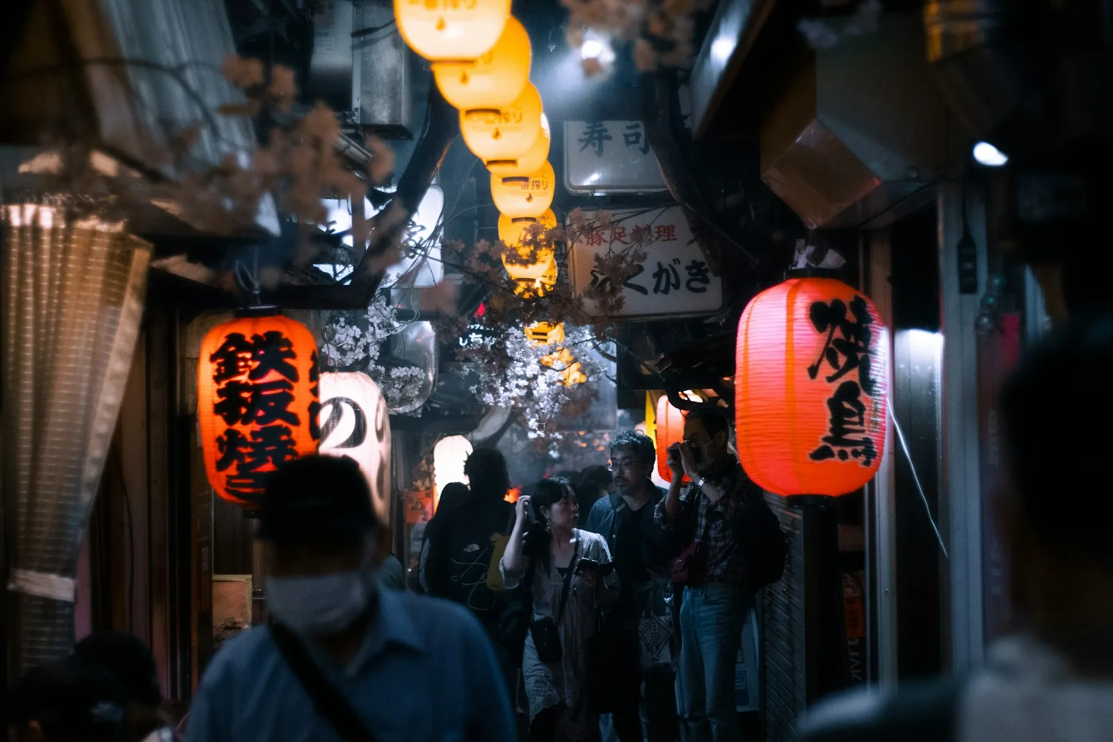 a group of people walking down a narrow street