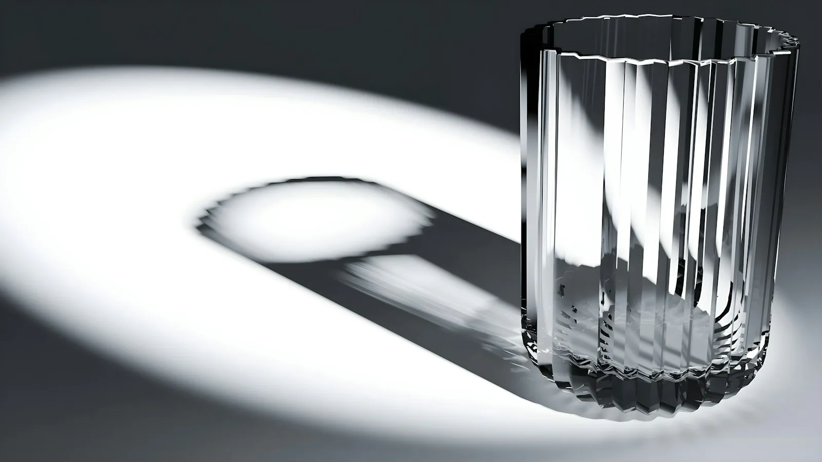 An Edo kiriko cut-glass tumbler casting a patterned shadow