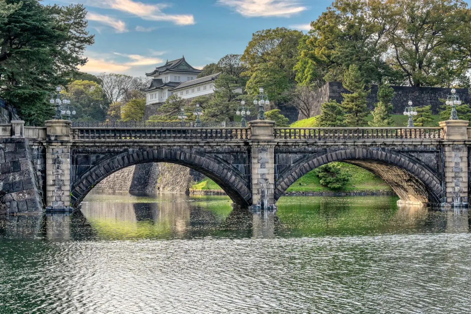 A bridge over a body of water with a building in the background