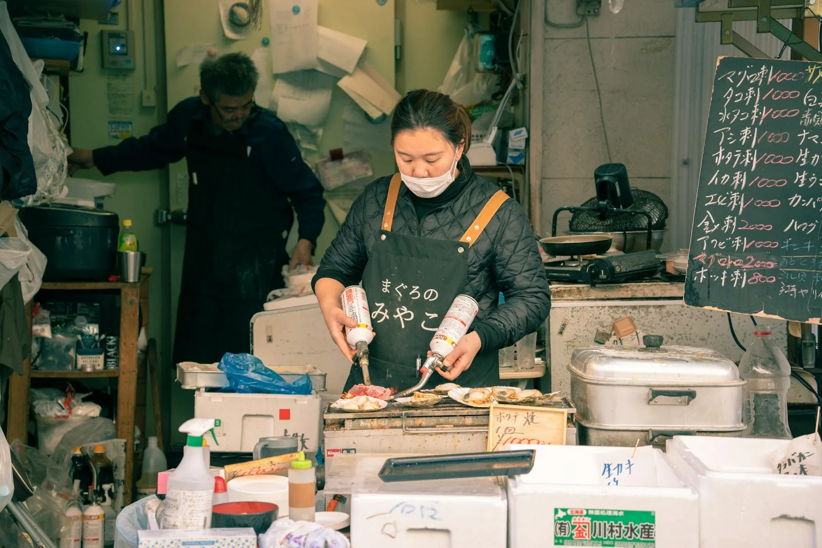 A vendor preparing seafood at Tsukiji Outer Market, Tokyo