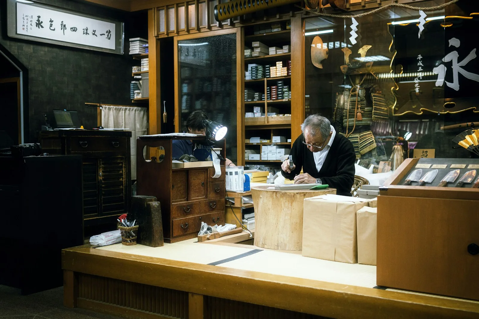 Elderly man working in a cluttered shop